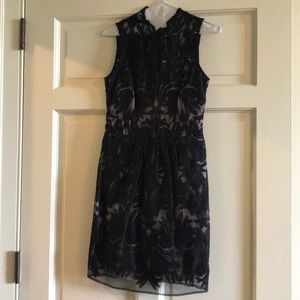 Black dress with nude underlay.